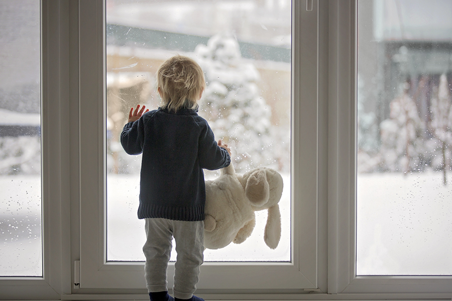Boy at window-Light in - winterize your home