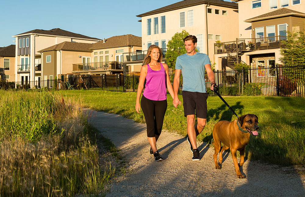 Couple walking on trail with dog